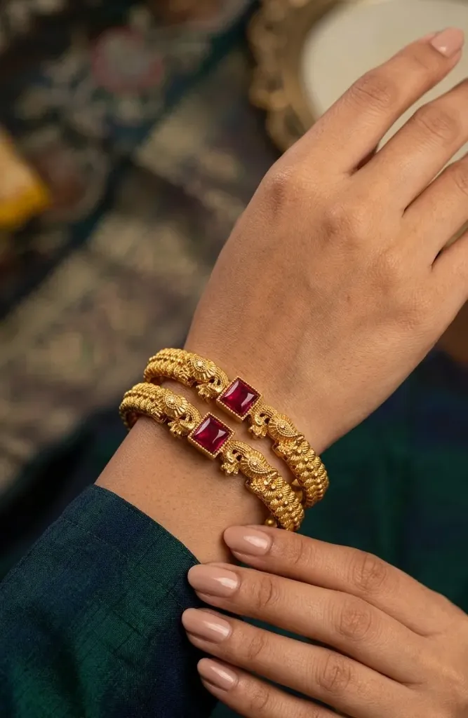 Statement bangles that redefine luxury-bold red gems framed in intricate gold artistry.