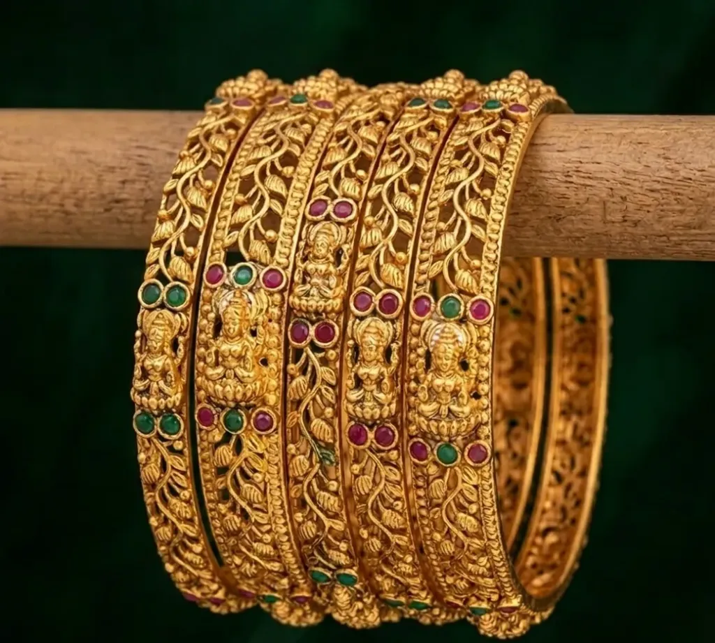 Bangles adorned with green and magenta gemstone, sparkling with festive vibrance. (2.4)