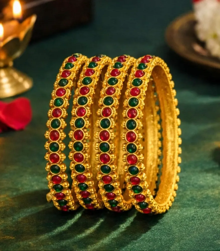 Stunning gold-toned bangles with alternating red and green gemstones. (2.4)