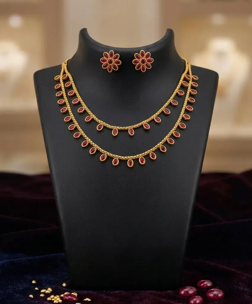 Luxurious double-layer necklace adorned with oval ruby stones paired with matching flower earrings.