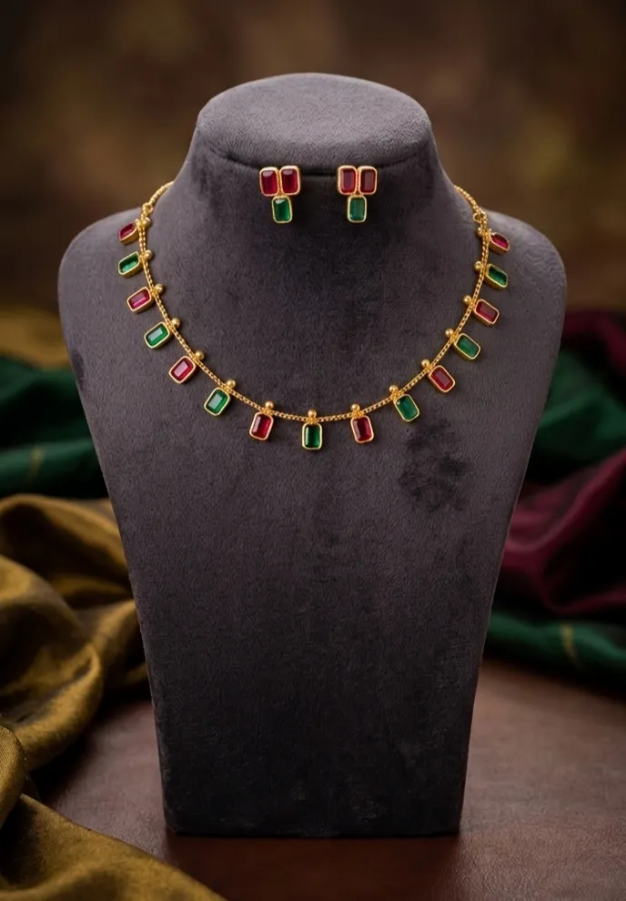 Experience the vibrant allure of traditional with our necklace and matching earrings, adorned with alternating ruby-pink and emerald - green stones.