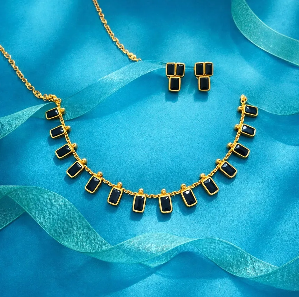 Golden elegance meets modern chic: a black-stone necklace & earring set that adds a bold, luxurious touch to any outfit.