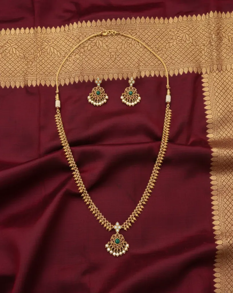 Short haram that blends tradition with elegance-golden artistry, emerald brilliance, and pearl grace.