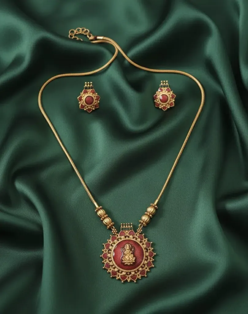 Dazzling short haram & earring set adorned with red gemstones & regal deity motif.
