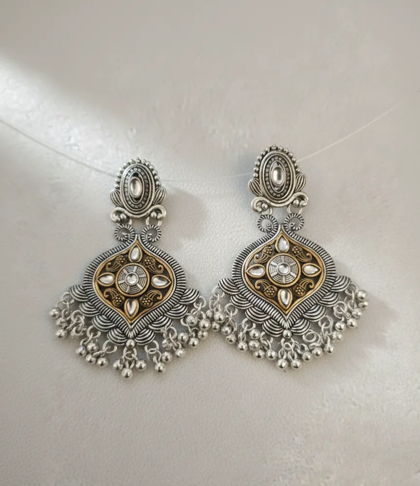 Timeless dual-tone oxidised earrings featuring an intricate antique silver frame with a radiant gold-toned center