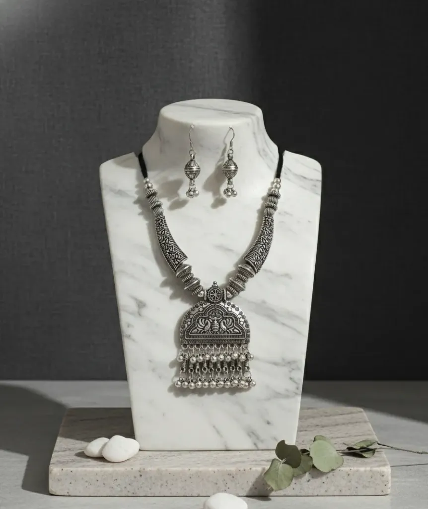 Detailed Oxidized pendant necklace paired with classic drop earrings-a must have for ethnic lovers.