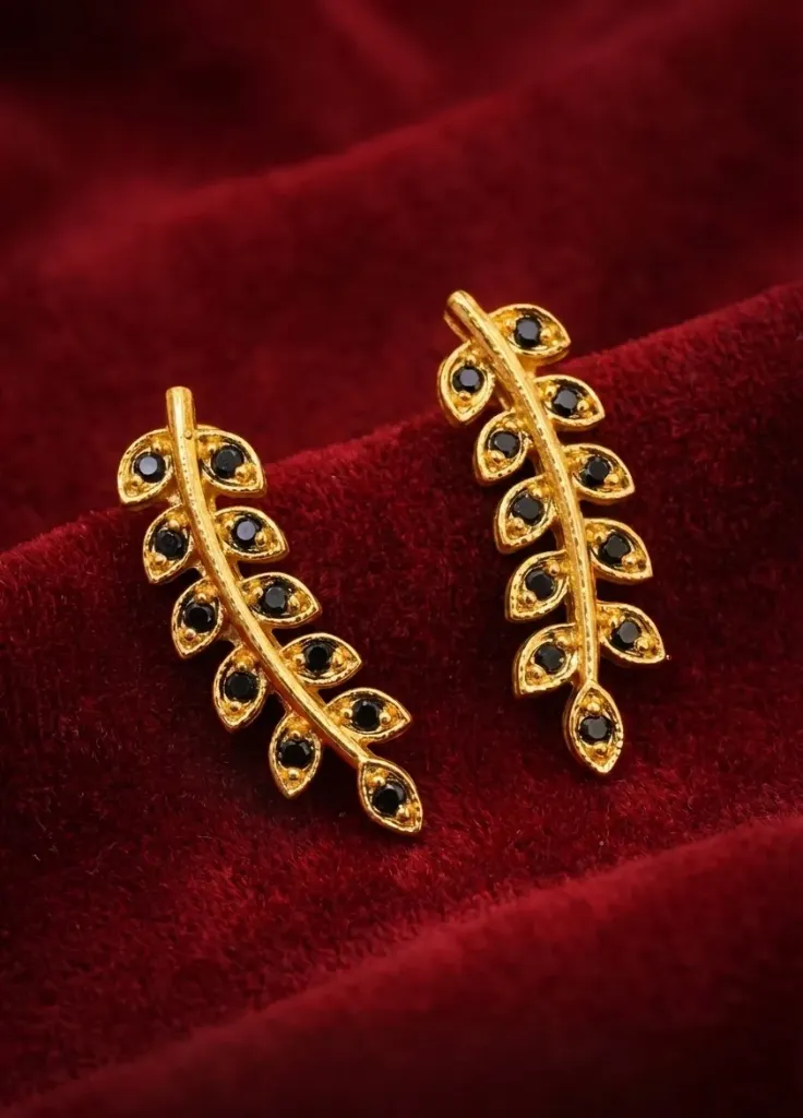 Leaf-Shaped Sud earrings in laid with black gemstones.