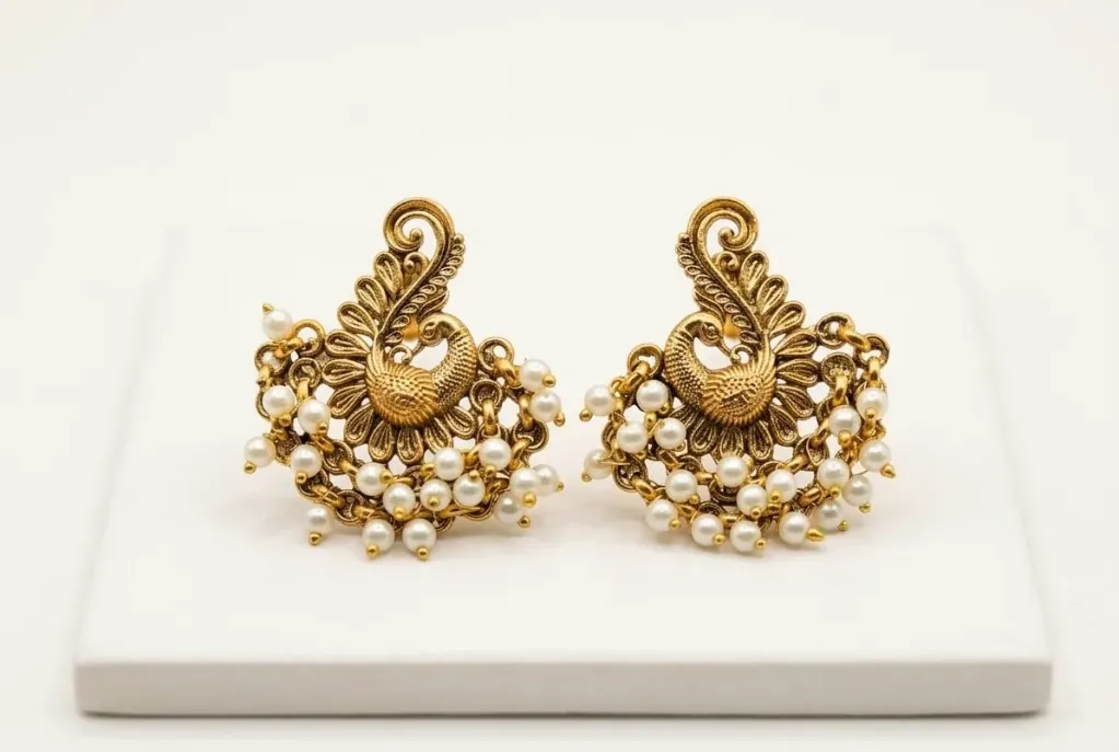 Golden Peacock earring adorned with pearl clusters.