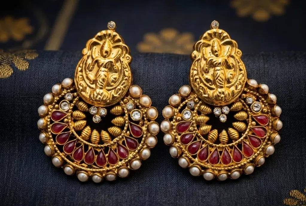 Elevate your style with our stunning golden earrings intricate filigree, ruby teardrop and pearl halos.