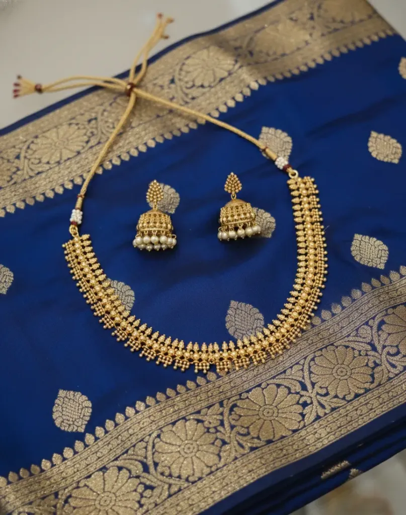 Radiate timeless elegance with this exquisite antique gold-toned necklace set, featuring intricate traditional craftsmanship and delicate pearl accents.