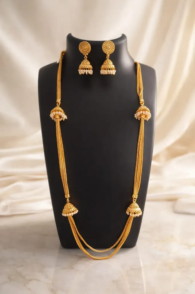 Embrace the golden heritage. This intricately crafted Jhumka-Style mala (Long Haram) set brings a touch of royal tradition to every occasion.