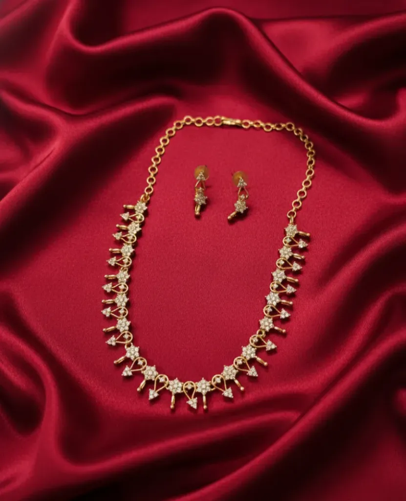 Dazzle in this exquisite AD necklace set, featuring delicate floral motifs and a brilliant gold-toned finish.