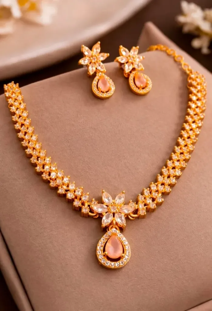 Add a touch of timeless elegance to your collection with exquisite gold toned AD neckless set, featuring delicate floral motifs and soft peach teardrop accents.
