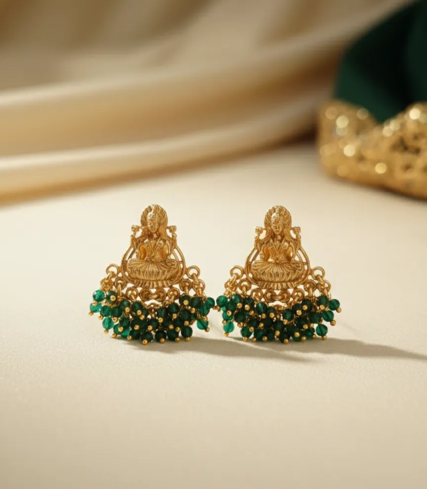 Exquisitely crafted gold-toned studs featuring a divine Goddess Lakshmi motif, intricately detailed for a timeless traditional look.