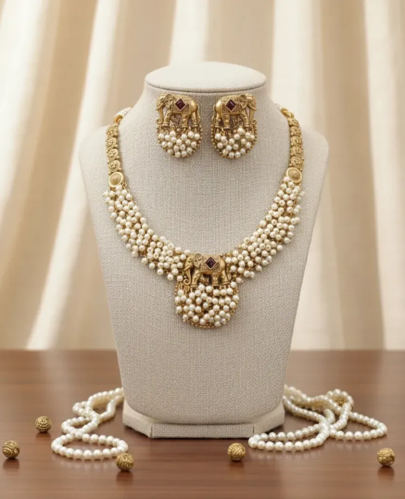 Capture the essence of heritage with this majestic elephant motif necklace set, featuring lustrous multi-layered pearls and a rich antique gold-toned finish.