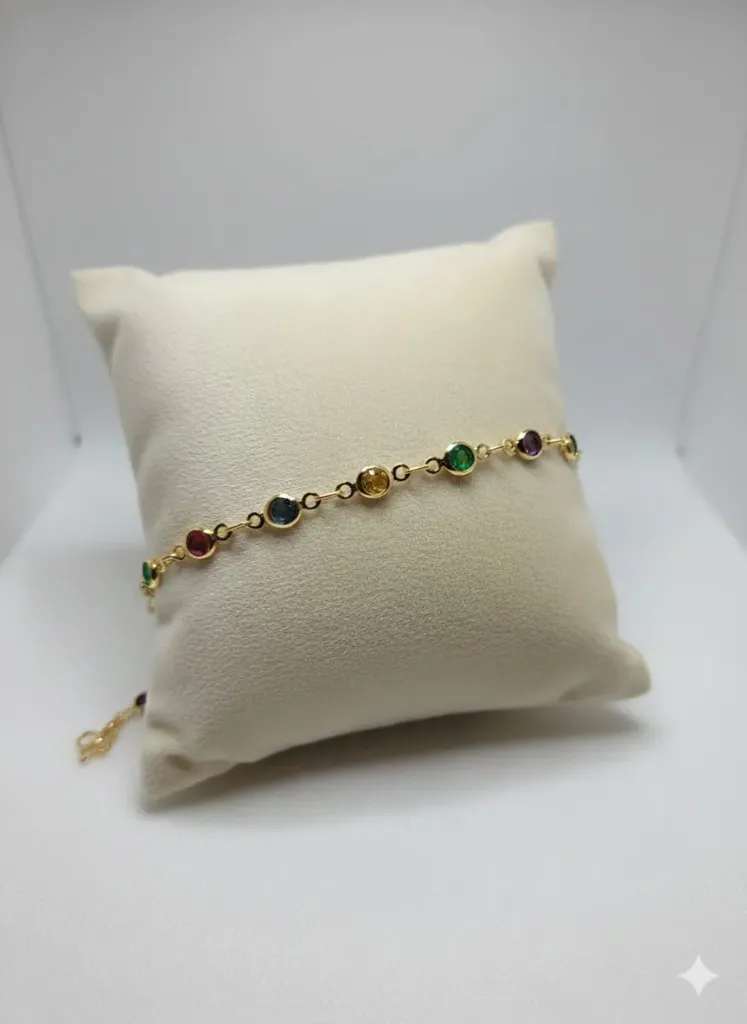Add a vibrant splash of color to your collection with this delicate gold-link bracelet, featuring a stunning sequence of bezel-set rainbow gemstones.