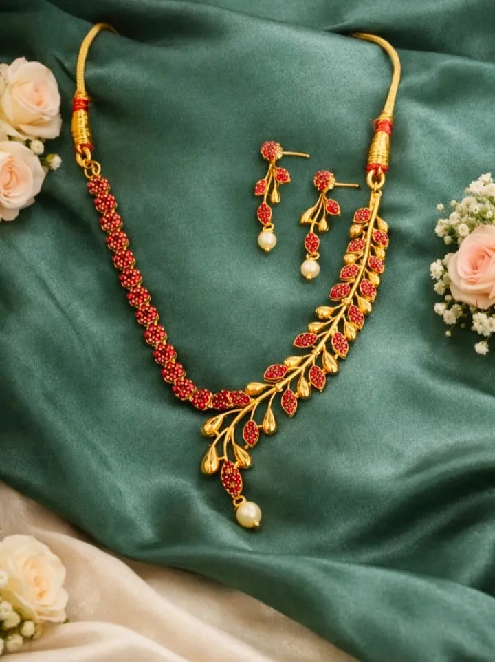 Red-Greenstone leaf necklace with gold finish & pearl drop, paired with matching earrings-classic festive elegance.
