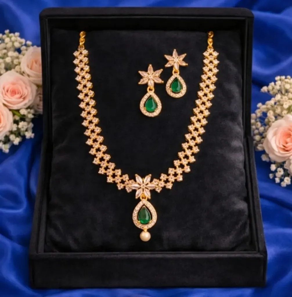 Add a touch of timeless elegance to your collection with exquisite gold toned AD neckless set, featuring delicate floral motifs and soft green teardrop accents.
