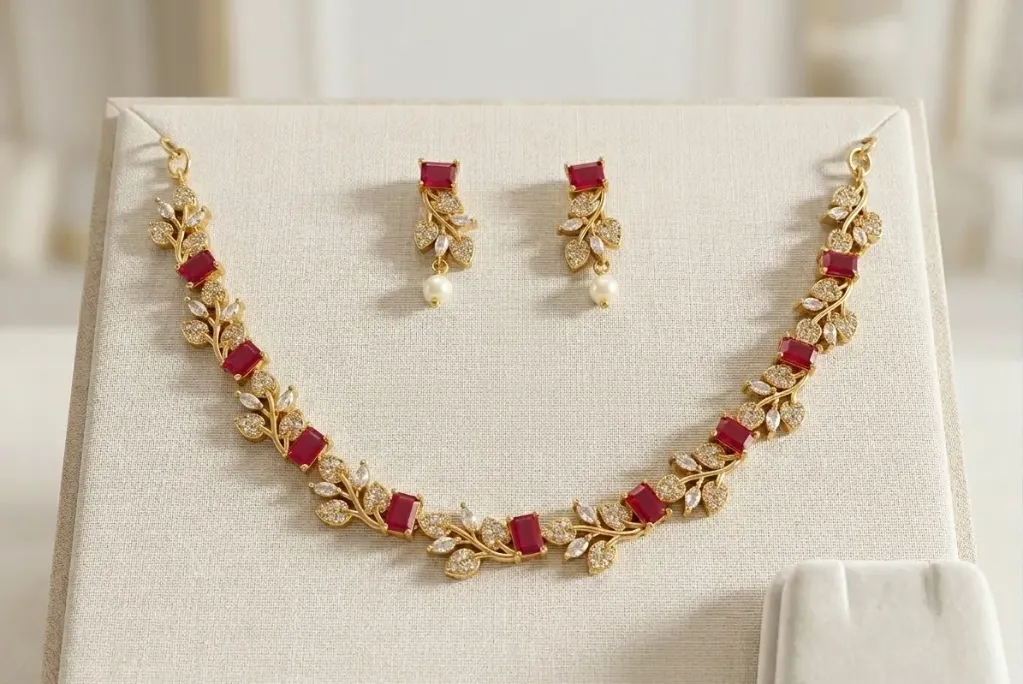 Stunning gold toned necklace set with elegant ruby-red square stones and sparkling white accents,paired with matching earring.