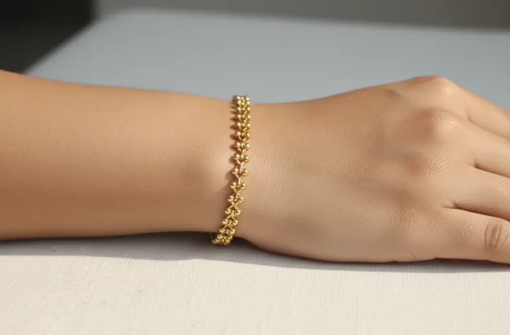 ​Elevate your look with this unique gold toned lattice-style bracelet, featuring a delicate rhythmic pattern of polished beads.