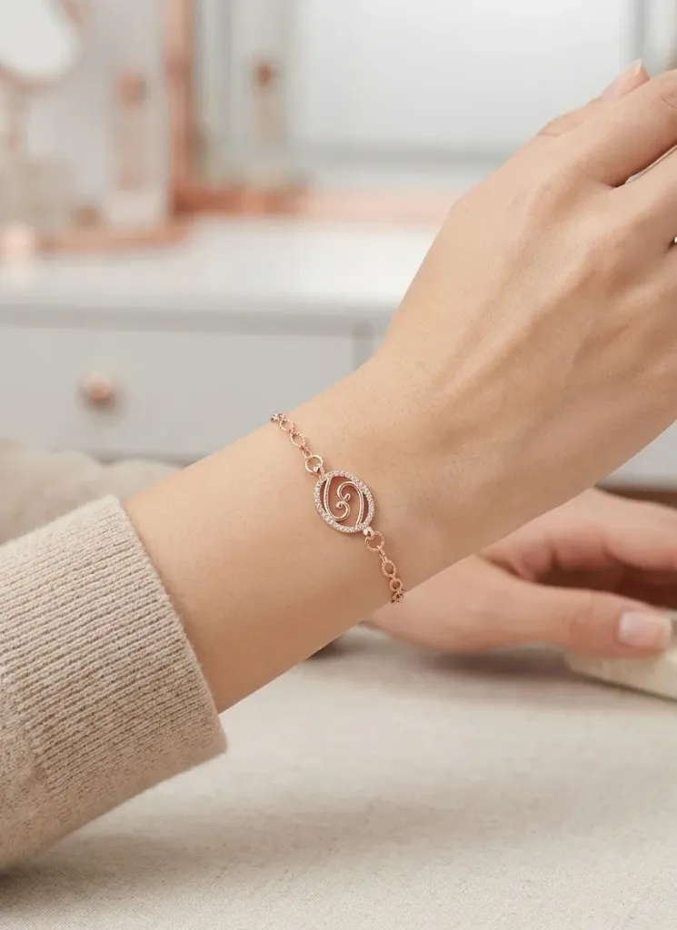 A stunning rose-gold bracelet with a diamond-encrusted oval charm.