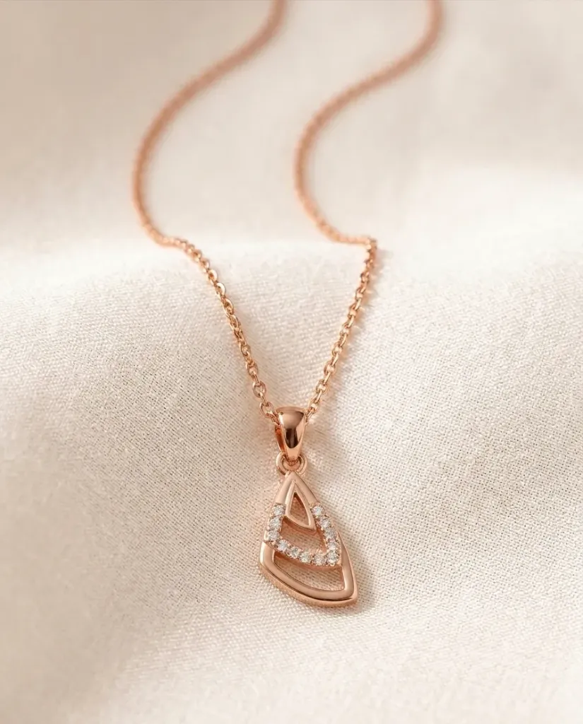 Luxe rose gold chain with a teardrop pendent featuring an open-work "A" inset with sparkling zirconia stones.