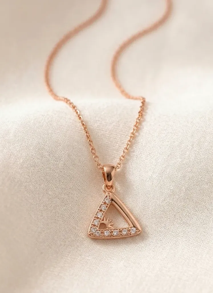 Delicate rose gold triangle pendent chain sparkling with tiny diamond accents and a sun motif at its centre.